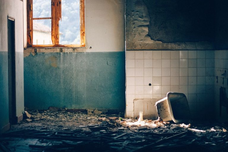 A dirty bathroom that looks like it has been destroyed by a dodgy bathroom renovator