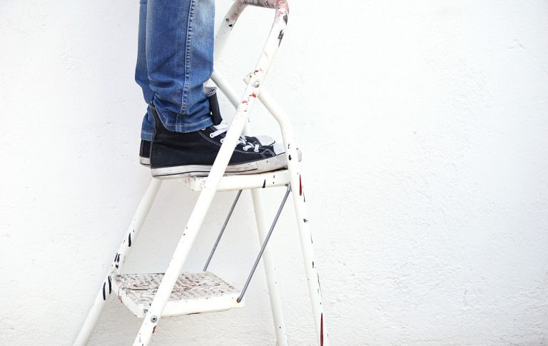 home renovator on a ladder